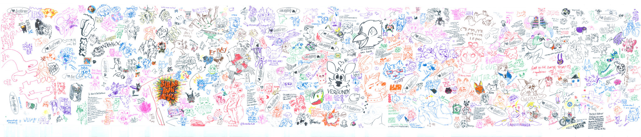A panoramic community art scroll filled with colorful drawings, characters, and handwritten messages.
